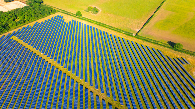 Aerial view of a large solar farm with rows of photovoltaic panels installed on green fields in Dorset England United Kingdom. Aerial view of a large solar farm with rows of photovoltaic panels installed on green fields in Dorset England United Kingdom.