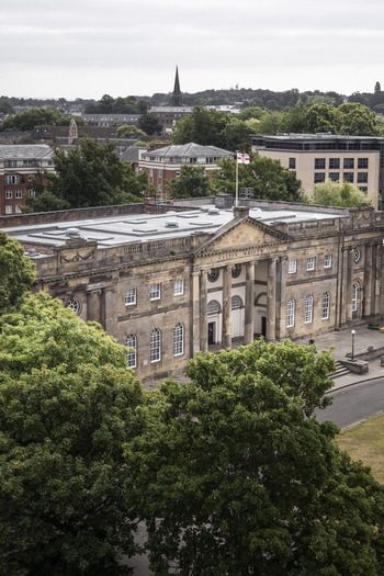 Aerial view of York Castle Museum with its neoclassical architecture surrounded by lush trees and urban cityscape in York England United Kingdom.