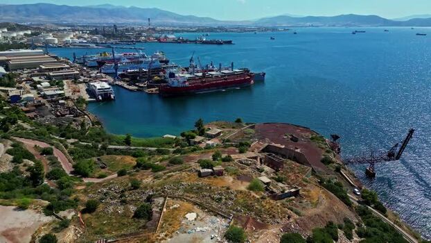 Aerial view of industrial shipyard and port facilities in Greece.