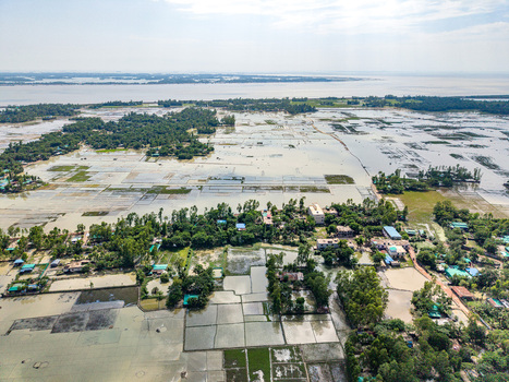 Aerial view of flooded agricultural fields and rural landscape with lush trees and water bodies in Banshkhali Upazila Chittagong Division Bangladesh. Aerial view of flooded agricultural fields and rural landscape with lush trees and water bodies in Banshkhali Upazila Chittagong Division Bangladesh.