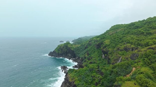 Aerial view of Bukit Pengilon cliffs and a waterfall Indonesia.