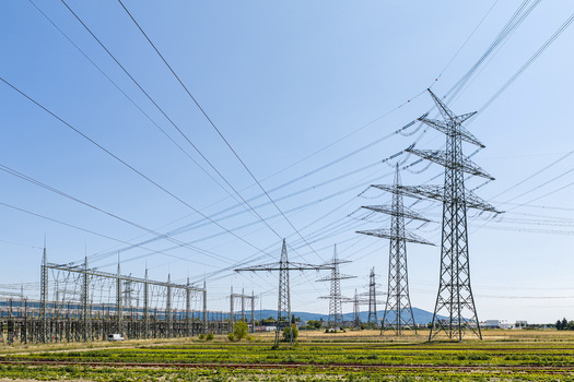 Aerial view of the Amprion Umspannwerk substation with high voltage electricity pylons and power lines stretching across agricultural fields in Pfungstadt Hessen Germany.