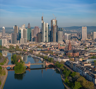 Aerial view of Frankfurt s modern skyscrapers historic cathedral and tranquil Main River under a blue sky Frankfurt am Main Hessen Germany.