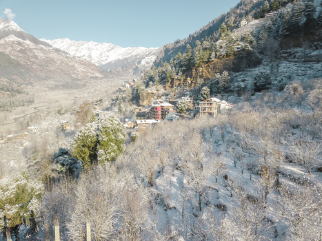 Aerial view of snowfall in the hills of vashisht area overlooking mountains of Himalayan range of Manali Himachal Pradesh India.