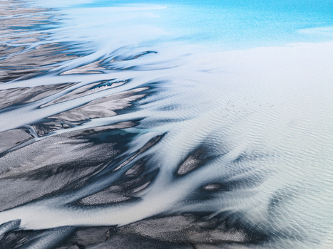 Aerial view of braided rivers create a stark contrast against the turquoise waters as nature s artistry unfolds from above Lake Tekapo Canterbury Region New Zealand. Aerial view of braided rivers create a stark contrast against the turquoise waters as nature s artistry unfolds from above Lake Tekapo Canterbury Region New Zealand.