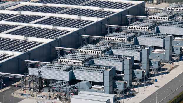 Aerial view of the Google Data Center facility with extensive rooftop solar panel arrays industrial cooling towers and complex infrastructure in Winschoten Groningen Netherlands.
