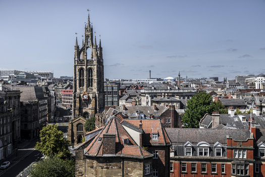 Aerial view of St. Nicholas Cathedral surrounded by historic red tiled rooftops and urban architecture in Newcastle upon Tyne England United Kingdom. Aerial view of St. Nicholas Cathedral surrounded by historic red tiled rooftops and urban architecture in Newcastle upon Tyne England United Kingdom.