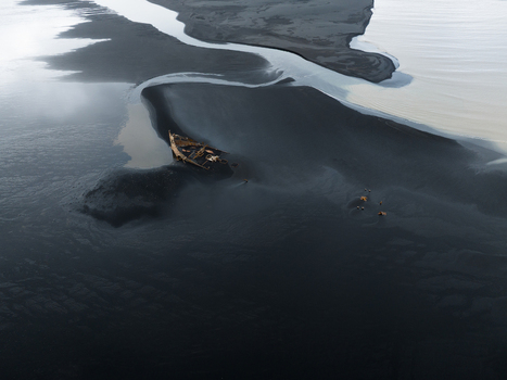 Aerial view of a stranded boat resting on the black sands where glacial rivers meet creating a stark contrast of textures and tones Skaftafell Iceland. Aerial view of a stranded boat resting on the black sands where glacial rivers meet creating a stark contrast of textures and tones Skaftafell Iceland.