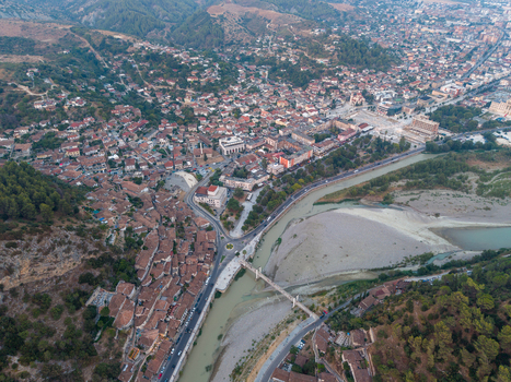 Aerial view of the historic city of Berat with its traditional houses terracotta rooftops and the Osum River flowing through the landscape in Berat Berat County Albania. Aerial view of the historic city of Berat with its traditional houses terracotta rooftops and the Osum River flowing through the landscape in Berat Berat County Albania.