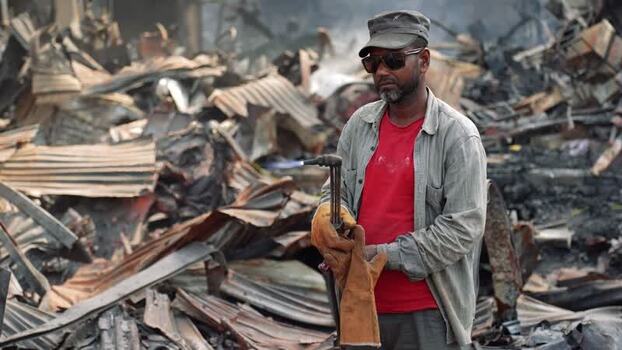 View of a man using a blowtorch amidst debris in Bangladesh. View of a man using a blowtorch amidst debris in Bangladesh.