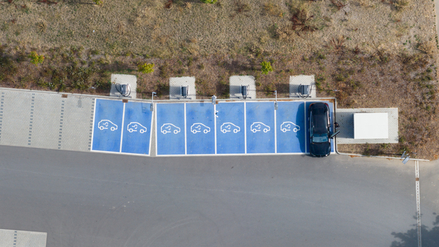 Aerial view of an electric vehicle charging station with blue marked parking spaces and charging units in Liederbach am Taunus Hessen Germany.