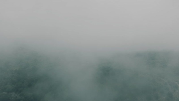 Aerial view of thick fog over green hills in Sarande Albania. Aerial view of thick fog over green hills in Sarande Albania.