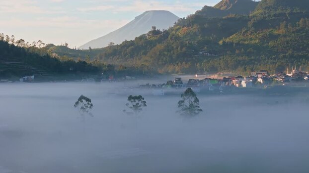 Aerial view of Dieng Plateau village in thick morning mist Indonesia. Aerial view of Dieng Plateau village in thick morning mist Indonesia.