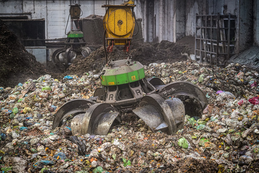 View of mechanical grapples moving organic waste at the Forsu Iren treatment plant in Reggio nell Emilia Emilia Romagna Italy. View of mechanical grapples moving organic waste at the Forsu Iren treatment plant in Reggio nell Emilia Emilia Romagna Italy.