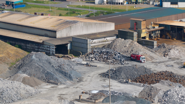 Aerial view of the Tata Steel industrial site with piles of scrap metal and large warehouses Velsen Noord Noord Holland Netherlands. Aerial view of the Tata Steel industrial site with piles of scrap metal and large warehouses Velsen Noord Noord Holland Netherlands.