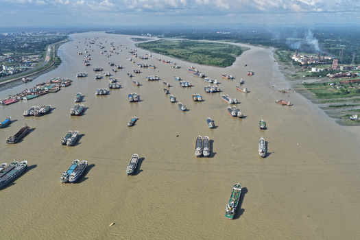 Aerial view of Karnaphuli River in Chattogram filled with numerous cargo ships and industrial vessels under a bright sky Chattogram Chattogram Division Bangladesh.
