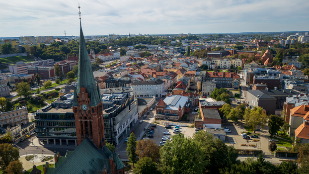 Aerial view of the towering steeple of the church piercing the skyline amidst a tapestry of red tiled roofs and verdant trees Bydgoszcz Województwo kujawsko pomorskie Poland. Aerial view of the towering steeple of the church piercing the skyline amidst a tapestry of red tiled roofs and verdant trees Bydgoszcz Województwo kujawsko pomorskie Poland.