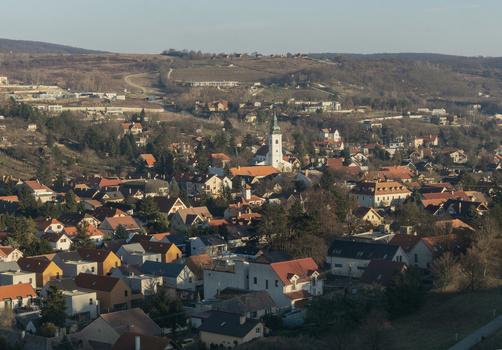 View of the historic Devin district featuring a white church with a green spire and red roofed houses nestled against rolling hills Bratislava IV Bratislava Region Slovakia. View of the historic Devin district featuring a white church with a green spire and red roofed houses nestled against rolling hills Bratislava IV Bratislava Region Slovakia.