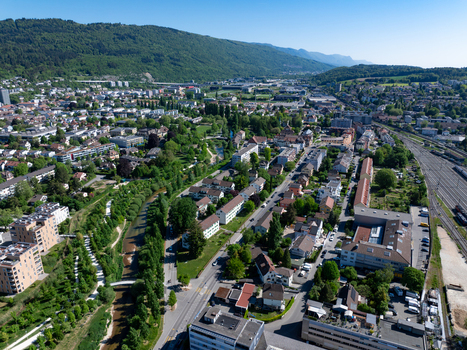 Aerial view of Biel Bienne Bozingenfeld Champ area with residential blocks the Suze river and railway tracks under a clear sky Biel Bienne Canton of Bern Switzerland.