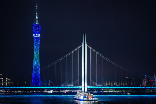Guangzhou Guangdong Province China 22 February 2024 View of the illuminated Canton Tower and Liede Bridge over the Pearl River at night in Guangzhou China. Guangzhou Guangdong Province China 22 February 2024 View of the illuminated Canton Tower and Liede Bridge over the Pearl River at night in Guangzhou China.