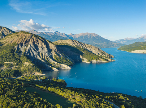 Rousset Serre Poncon France 19 September 2026 Aerial view of Lac de Serre Poncon surrounded by rugged alpine peaks forested slopes and deep blue reservoir waters. Rousset Serre Poncon France 19 September 2026 Aerial view of Lac de Serre Poncon surrounded by rugged alpine peaks forested slopes and deep blue reservoir waters.