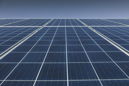 View of solar panels arranged in a grid pattern against a clear blue sky in Tartu County Estonia. View of solar panels arranged in a grid pattern against a clear blue sky in Tartu County Estonia.
