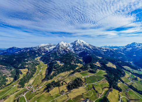 Aerial view of verdant valleys and majestic snow dusted peaks under a serene sky Windischgarsten Upper Austria Austria. Aerial view of verdant valleys and majestic snow dusted peaks under a serene sky Windischgarsten Upper Austria Austria.