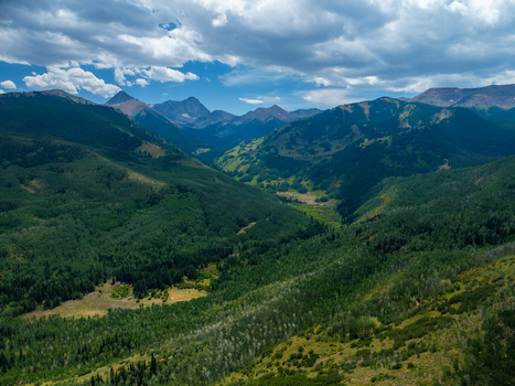Aerial view of Capitol Peak and the surrounding lush green valleys of the Elk Mountains near Aspen Colorado United States. Aerial view of Capitol Peak and the surrounding lush green valleys of the Elk Mountains near Aspen Colorado United States.
