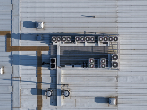 Aerial view of industrial factory roof featuring multiple HVAC units and ventilation systems in Melbourne VIC Australia. Aerial view of industrial factory roof featuring multiple HVAC units and ventilation systems in Melbourne VIC Australia.