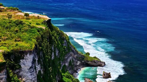 Aerial view of lush green cliffs along the coast of Bali Indonesia.