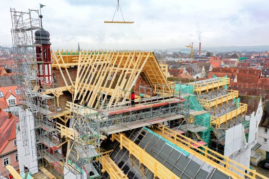 Aerial view of Rathaus Forchheim under renovation with wooden roof trusses scaffolding and workers under an overcast sky Forchheim Bayern Germany. Aerial view of Rathaus Forchheim under renovation with wooden roof trusses scaffolding and workers under an overcast sky Forchheim Bayern Germany.