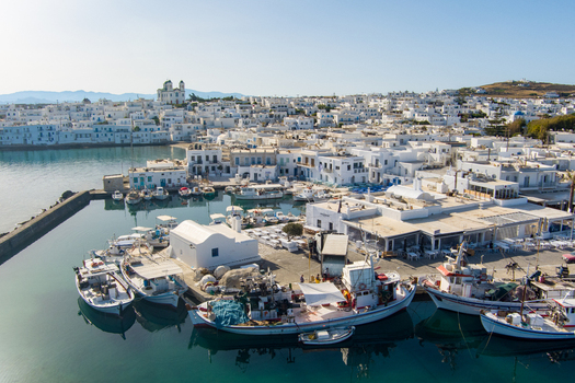 Naoussa Greece 21 September 2026 Aerial view of the picturesque harbor of Naoussa on Paros island featuring traditional white buildings fishing boats and clear blue waters. Naoussa Greece 21 September 2026 Aerial view of the picturesque harbor of Naoussa on Paros island featuring traditional white buildings fishing boats and clear blue waters.