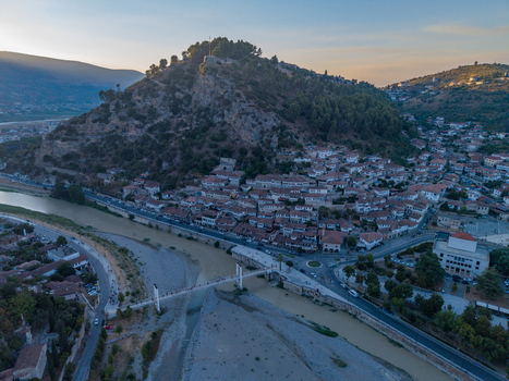 Aerial view of the historic Berat Castle and traditional white houses along the Osum River in Berat Berat County Albania.