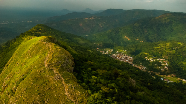 Aerial view of Mt. Gemi with its prominent ridge overlooking the village of Amedzofe nestled in the lush green hills of the Volta Region Ghana. Aerial view of Mt. Gemi with its prominent ridge overlooking the village of Amedzofe nestled in the lush green hills of the Volta Region Ghana.