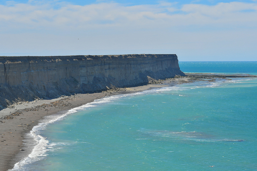 View of Puerto Piramides cliffs overlooking the turquoise Atlantic Ocean and a sea lion colony on the beach Puerto Madryn Chubut Argentina. View of Puerto Piramides cliffs overlooking the turquoise Atlantic Ocean and a sea lion colony on the beach Puerto Madryn Chubut Argentina.