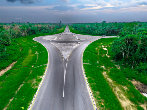 Aerial view of the roundabout on Bonny Island surrounded by lush green vegetation and forest in Bonny Town Rivers Nigeria. Aerial view of the roundabout on Bonny Island surrounded by lush green vegetation and forest in Bonny Town Rivers Nigeria.