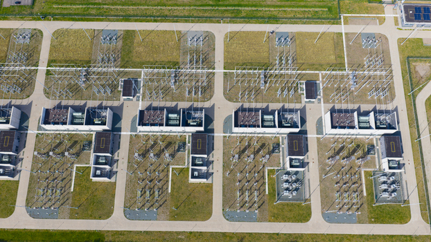 Aerial view of an electrical substation with transformers power lines and industrial buildings on a sunny day in Velsen Noord North Holland Netherlands.