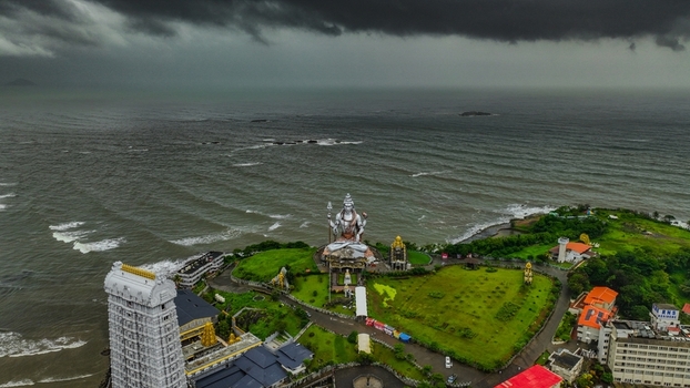 Aerial view of the monumental Shiva statue and Murudeshwar Temple complex situated on a coastal cliff overlooking the Arabian Sea in Murdeshwar Karnataka India.