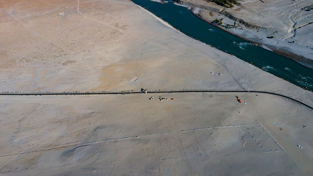 Aerial view of Sarfaranga Cold Desert Shigar with a winding road and a river flowing through the arid landscape in Skardu Gilgit Baltistan Pakistan.