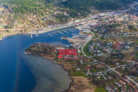 Aerial view of the marina and red roofed buildings in the coastal town of Henan Vastra Gotaland Sweden. Aerial view of the marina and red roofed buildings in the coastal town of Henan Vastra Gotaland Sweden.