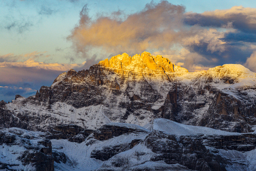 Aerial view of the Dolomites Cima Undici and Cresta Zsigmondy kissed by the sun s golden light a majestic dance of shadow and snow Cortina d Ampezzo Veneto Italy. Aerial view of the Dolomites Cima Undici and Cresta Zsigmondy kissed by the sun s golden light a majestic dance of shadow and snow Cortina d Ampezzo Veneto Italy.