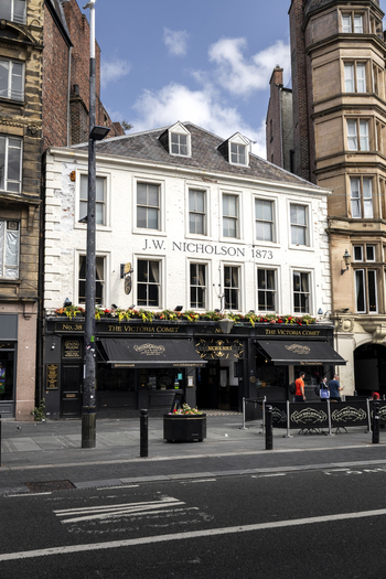 Newcastle upon Tyne United Kingdom 13 July 2026 View of The Victoria Comet pub with its historic white facade and black storefront in the city center. Newcastle upon Tyne United Kingdom 13 July 2026 View of The Victoria Comet pub with its historic white facade and black storefront in the city center.