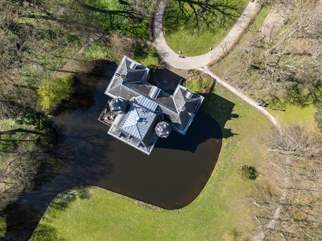 Aerial view of Landgoed Oud Poelgeest castle surrounded by a dark moat and verdant parkland Oegstgeest Zuid Holland Netherlands. Aerial view of Landgoed Oud Poelgeest castle surrounded by a dark moat and verdant parkland Oegstgeest Zuid Holland Netherlands.