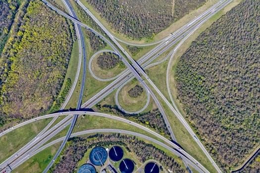 Aerial view of the cloverleaf interchange cutting through the lush landscape a symphony of concrete and nature s artistry Sausheim Grand Est France.