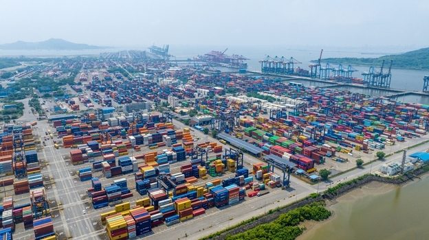 Aerial view of Jawaharlal Nehru Port Authority featuring rows of colorful shipping containers industrial cranes and port infrastructure in Juna Sheva Maharashtra India. Aerial view of Jawaharlal Nehru Port Authority featuring rows of colorful shipping containers industrial cranes and port infrastructure in Juna Sheva Maharashtra India.
