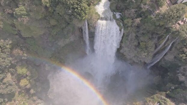 Aerial view of Marmore Falls cascading down green cliffs Italy.