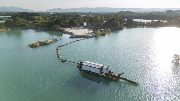 Aerial view of the Extraccion de aridos Lima S.L. sand extraction site with a floating dredger and pipeline on a turquoise lake in Vilarino das Poldras Ourense Spain. Aerial view of the Extraccion de aridos Lima S.L. sand extraction site with a floating dredger and pipeline on a turquoise lake in Vilarino das Poldras Ourense Spain.