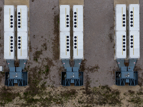 Aerial view of Chapel Farm Energy Park featuring rows of white battery storage containers with cooling fans on gravel ground in Luton England United Kingdom. Aerial view of Chapel Farm Energy Park featuring rows of white battery storage containers with cooling fans on gravel ground in Luton England United Kingdom.