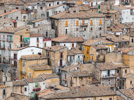 Aerial view of the dense cluster of historic stone houses and terracotta tiled roofs in the medieval village of Pacentro Abruzzo Italy. Aerial view of the dense cluster of historic stone houses and terracotta tiled roofs in the medieval village of Pacentro Abruzzo Italy.