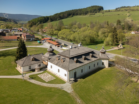 Aerial view of Kastiel Kubinyi manor house with its traditional shingle roofs and surrounding green parkland under a clear blue sky in Vysny Kubin Zilinsky kraj Slovakia. Aerial view of Kastiel Kubinyi manor house with its traditional shingle roofs and surrounding green parkland under a clear blue sky in Vysny Kubin Zilinsky kraj Slovakia.